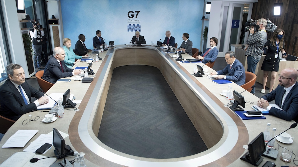 The leaders of the Group of Seven sit around a working table.