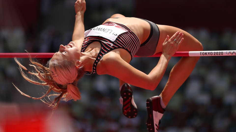 An athlete passes over the bar during a high jump event.