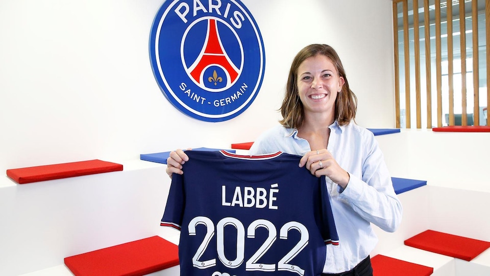 A player presents her new jersey.