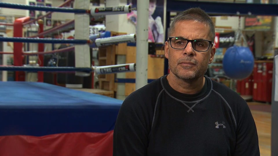 Man being interviewed at a boxing gym