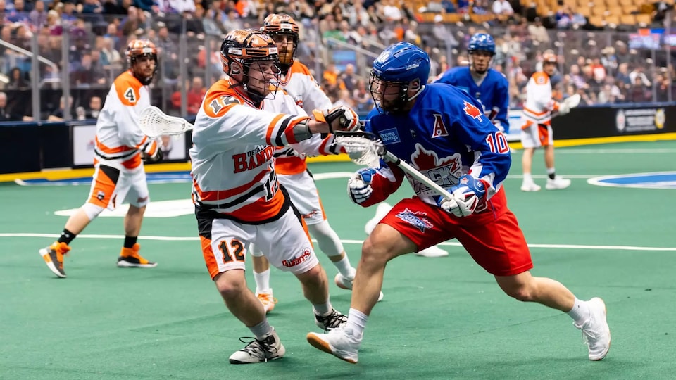 A Toronto Rock player walks around an opponent during a game at the Scotiabank Arena in Toronto.