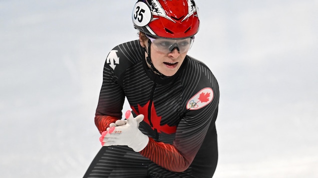 Speed ​​skater Kim Putine rubs her hands after a race.