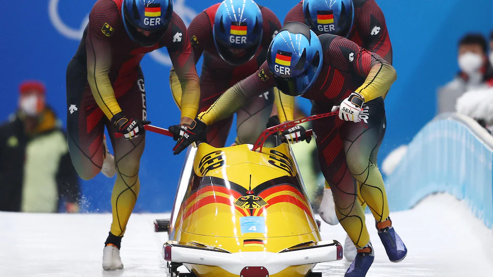 Four German skaters are about to jump aboard their machines. 