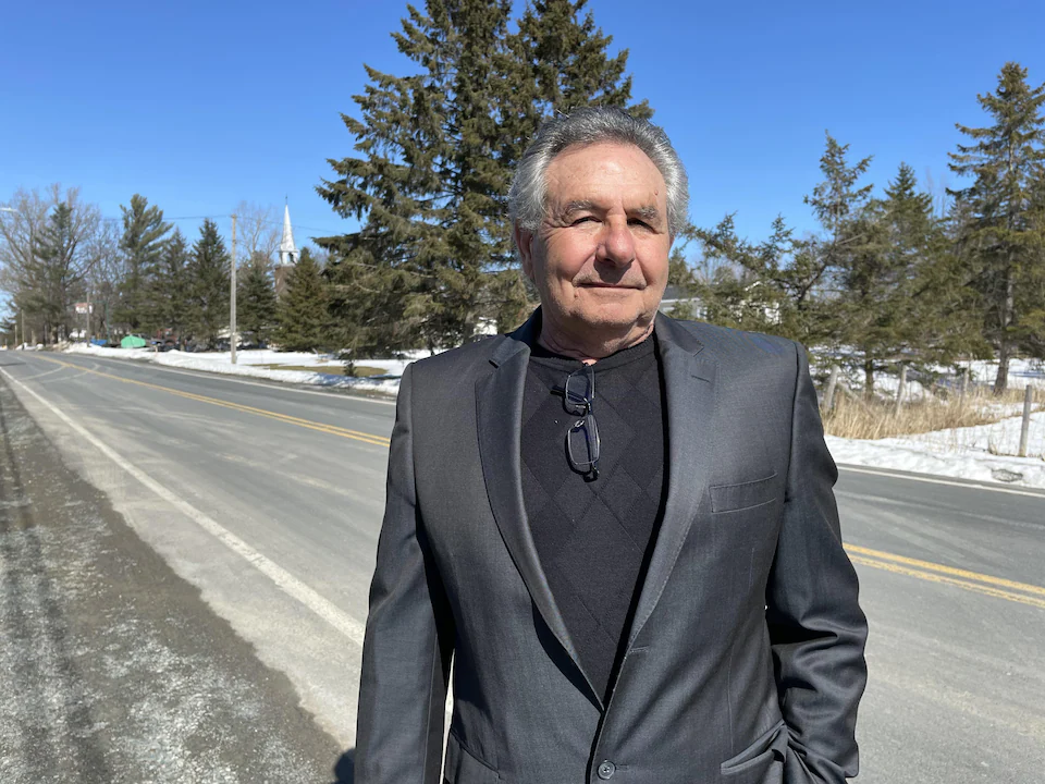 Michel Cotier in front of a road in Bethany. 