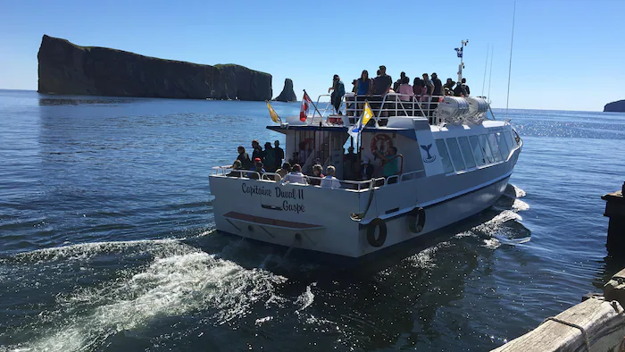 A boat full of tourists leaves the quay for an island
