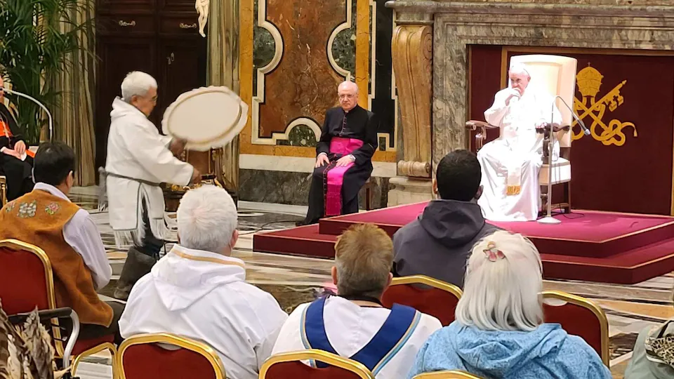 The man plays the drum in front of the Pope. 