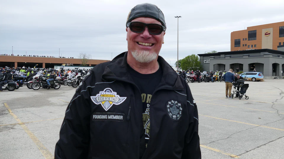 Ed Junner smiling with motorcycles ready to go
