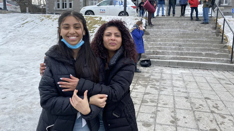 Ensaf Haider hugs her daughter Najwa in front of Sherbrooke City Council.