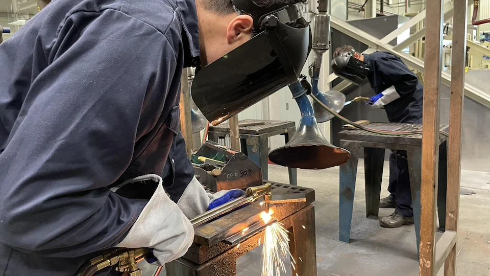 Student doing welding at his work station.