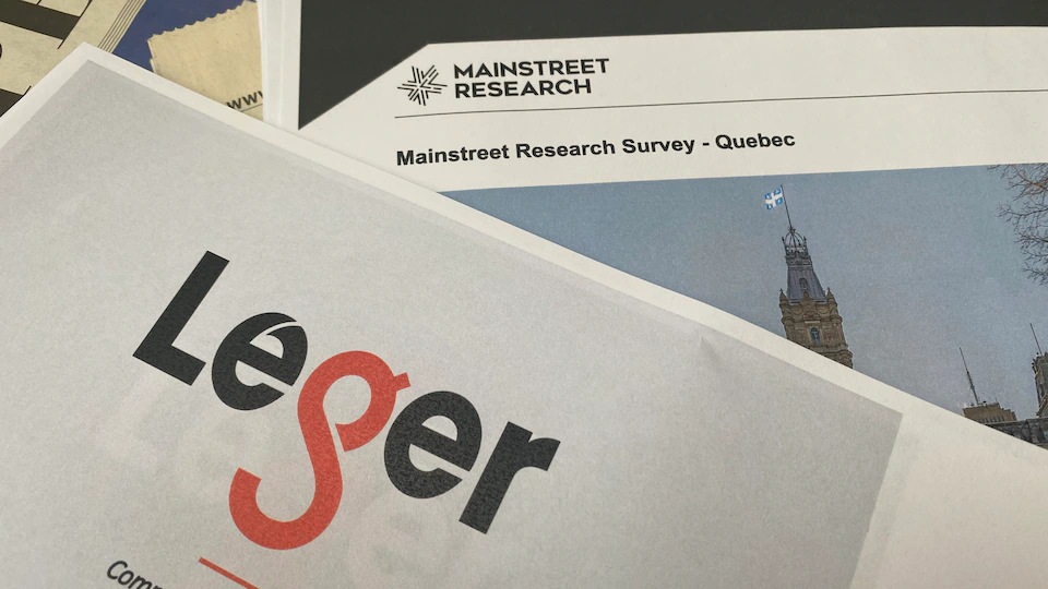 A stack of Leger and Mainstreet Research surveys.